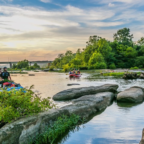 a small clock tower next to a body of water