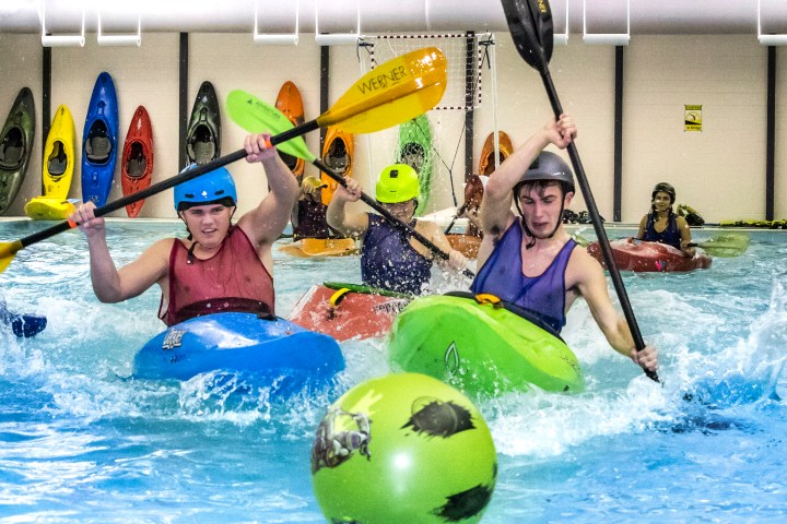 a girl riding a wave on a surfboard in the water