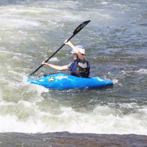 a person riding a surf board on a body of water