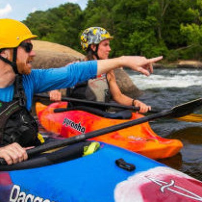 a man riding on the back of a boat in the water