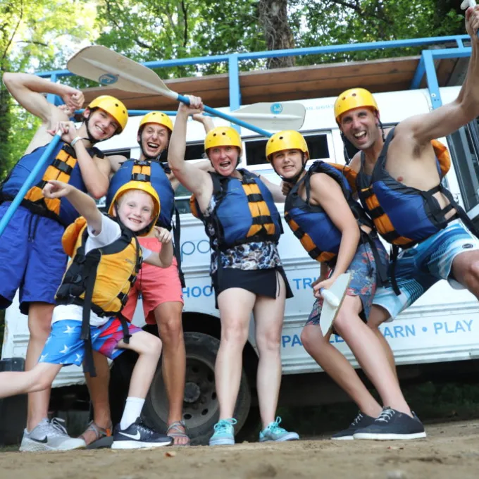 a group of people on a beach posing for the camera
