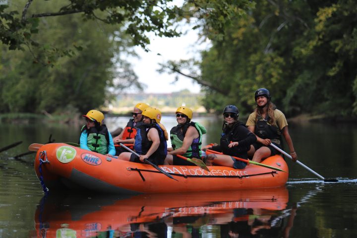 a group of people riding on the back of a boat