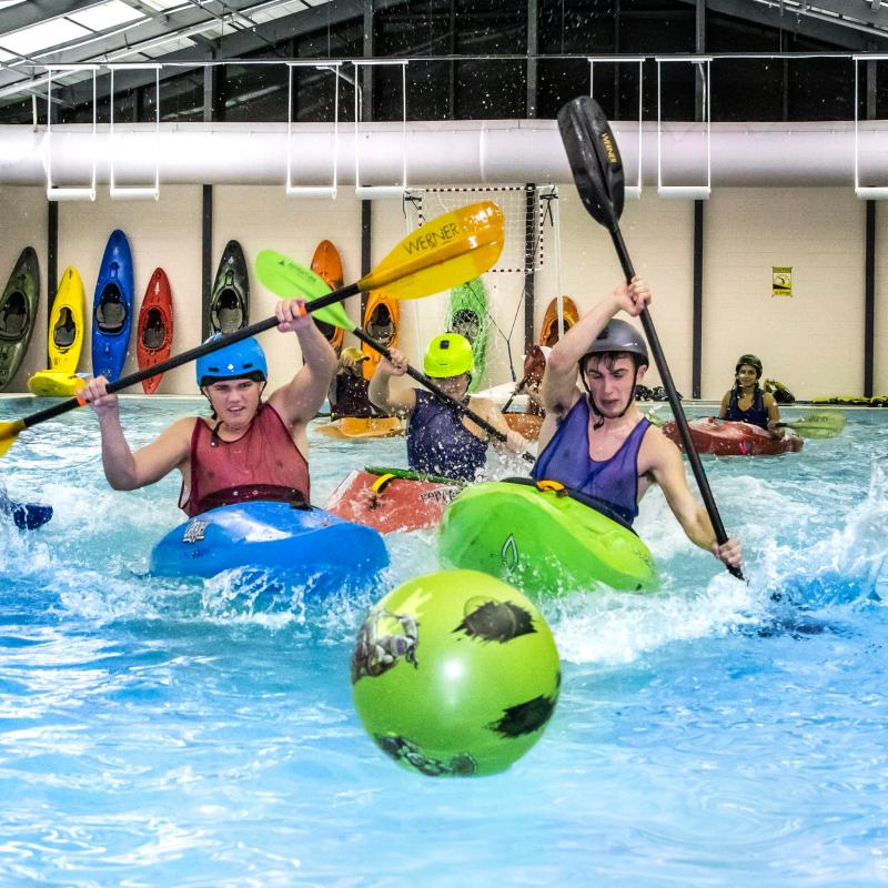 a group of people in a pool of water