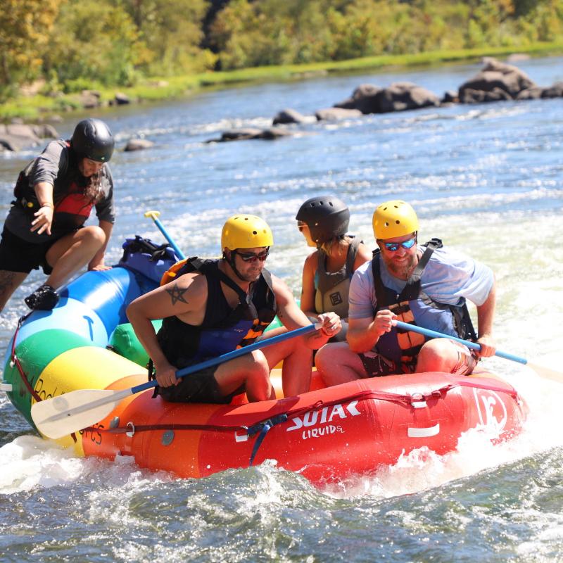 a group of people on a raft in a body of water