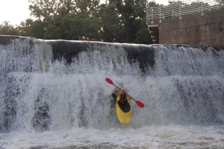a man riding a snow board in the water