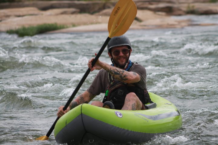 a person riding a surf board on a body of water