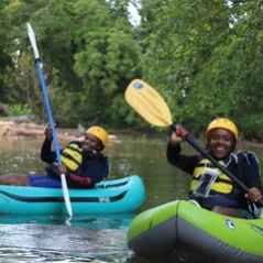 a person riding on the back of a boat in the water