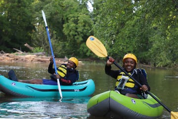 a person riding on the back of a boat in the water