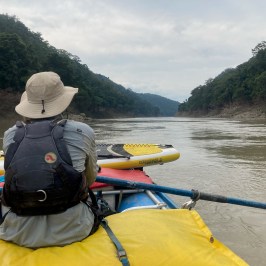 a person standing next to a body of water