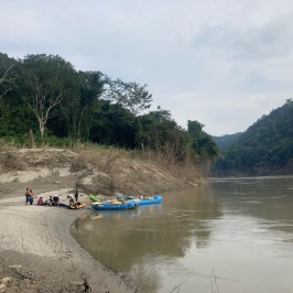 a group of people standing next to a body of water