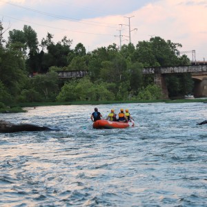 a boat traveling along a river next to a body of water