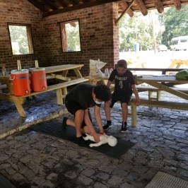 a person sitting on a bench in front of a brick building