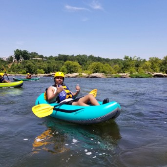 a group of people on a raft in a body of water