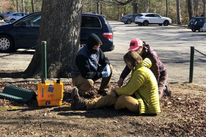 a person sitting in a parking lot