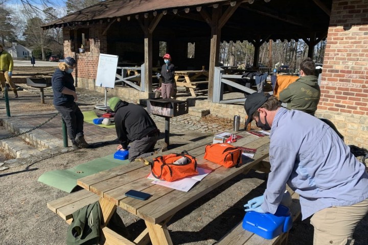 a group of people sitting at a table in front of a building