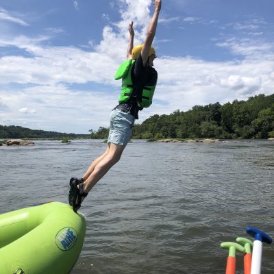 a man flying through the air over a body of water