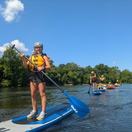 a person standing next to a body of water