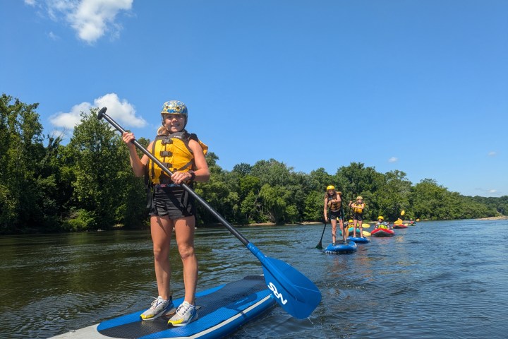 a person standing next to a body of water