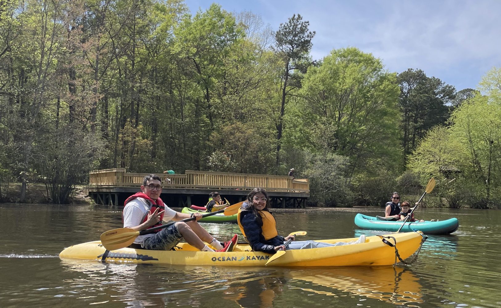 a group of people riding on the back of a boat in the water