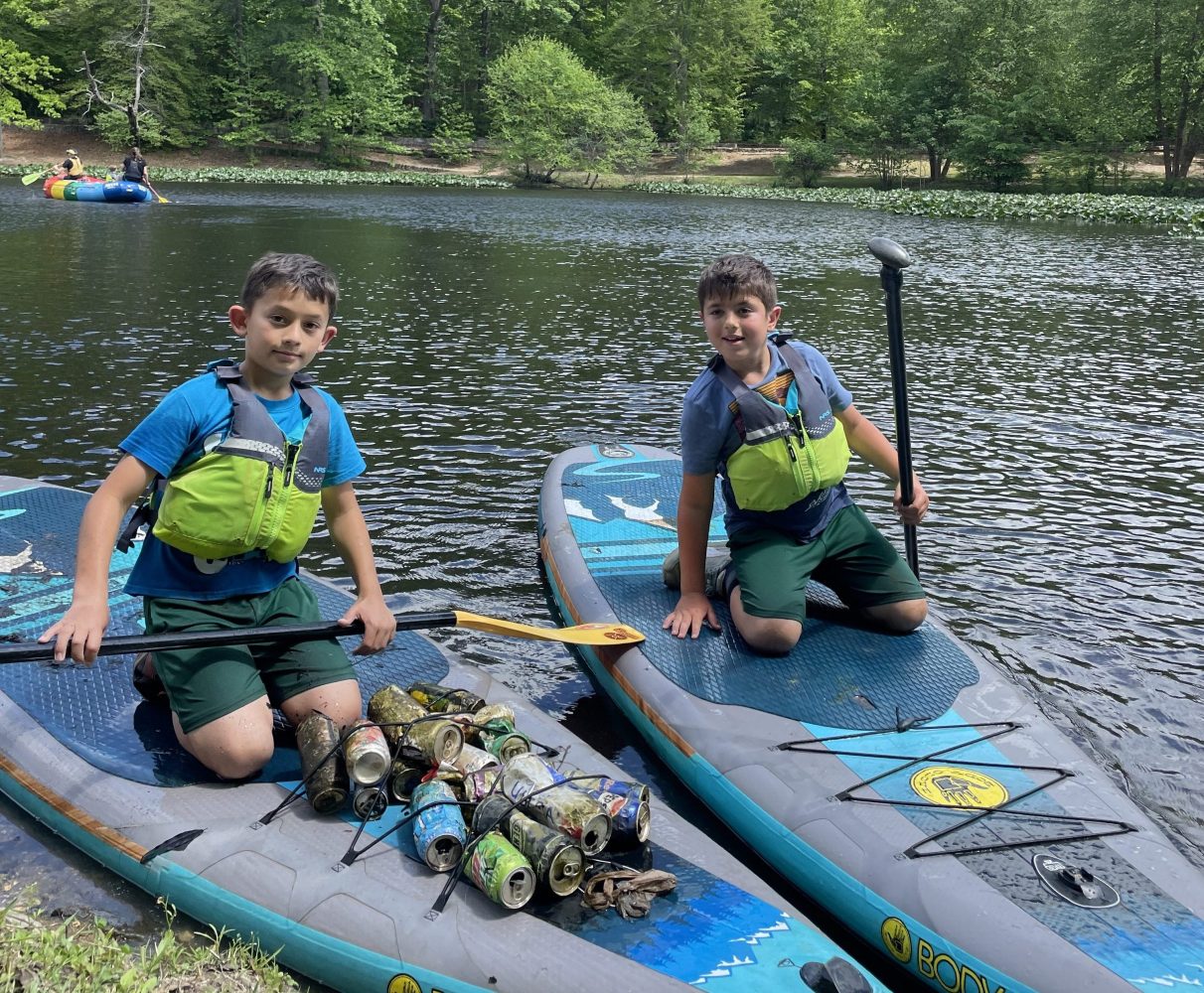 a group of people sitting on a raft in a body of water