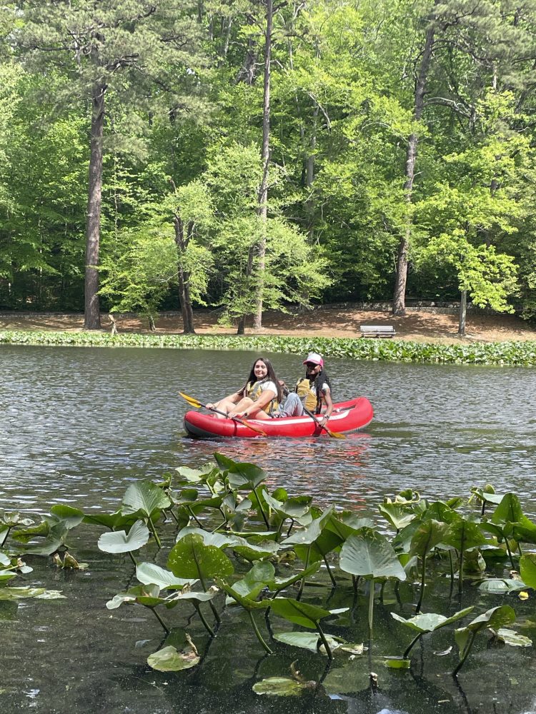 a group of people in a small boat in a body of water